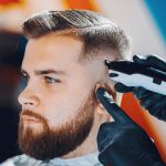 Man with a beard. Hairdresser with a client.