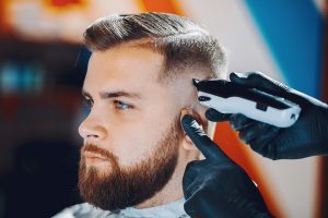 Man with a beard. Hairdresser with a client.